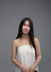 Obraz premium The woman wore a white strapless dress and smiled happily.