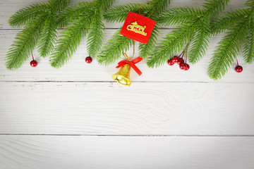 Christmas background wood composition fir branches and red berries / christmas decoration pine tree with bell festive xmas winter and Happy New Year object holiday concept