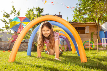 Cute beautiful girl on playground pass tunnel