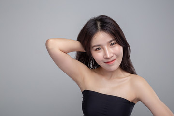 Fototapeta premium The woman wearing black strapless tops and hands touch her hair.
