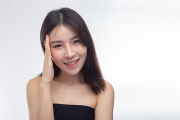 Women wearing black strapless blouses and hands touching the face on the eyebrows.