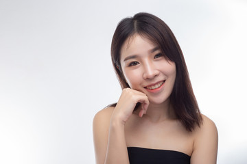 Fototapeta premium The woman wore a black strapless dress and hands touch her face.