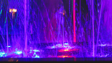 splashing water in a fountain with multi-colored light