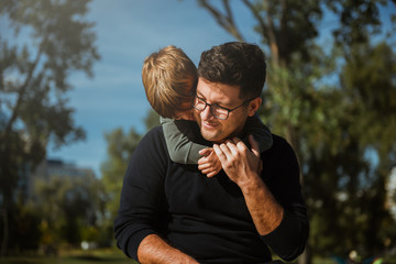 Young father with boy on shoulders