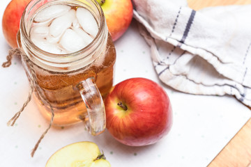 Apple juice freshly made in home kitchen with healthy chopped apples on the table