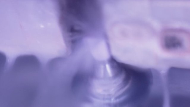 Ultra close up of dental crown being milled in Cerec machine