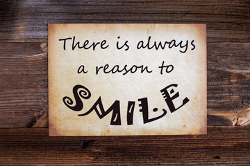 Old Grungy Paper With English Quote There Is Always A Reason To Smile. Wooden Background