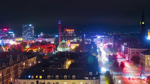 Copenhagen, Denmark. Aerial view of city center at night in Copenhagen, Denmark. Time-lapse with car traffic and illuminated buildings, park Tivoli, panning video