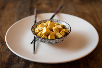 vegan food: tofu with curry and sesame seeds