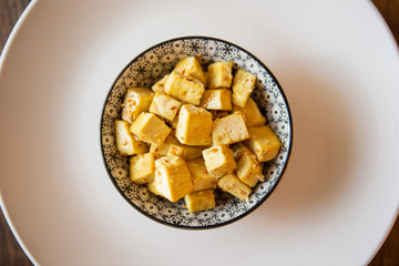 tofu bowl with curry and sesame seeds, view from the top