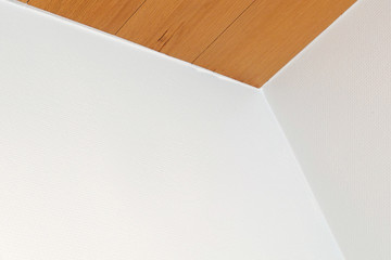 Corner of the room. white walls and brown ceiling. Abstract geometric architecture detail. Space for text.