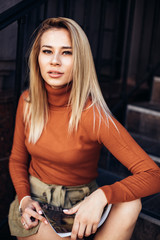Amazing joyful pretty girl with long hair. posing outdoor. Close up fashion street stile...