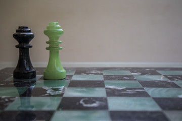 Chess pieces on a marble chessboard