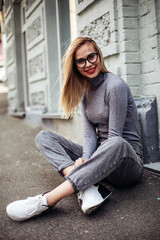 portrait of cheerful white woman in glasses.fashionable girl with beautiful hair smiling to camera.