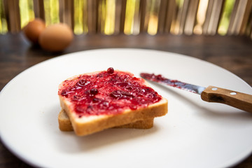 breakfast with bread and berries jam, close up view
