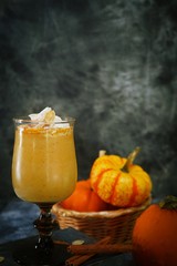 Pumpkin spice latte Smoothie / Pumpkin Spice Latte Smoothie / Fall autumn drink on rustic dark background, selective focus