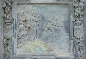 Jesus Christ tempted by Devil in the desert, sculpture work from Giambologna's school, collocated in the left portal of the Cathedral St. Mary of the Assumption in Pisa, Italy 