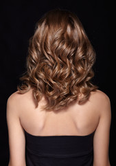 Fototapeta premium Woman from backside with curly hair
