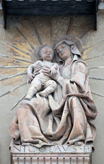 Fototapeta na wymiar Virgin Nary with baby Jesus statue on house facade in Bologna, Italy