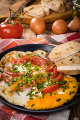 Homemade breakfast fried egg with tomato.