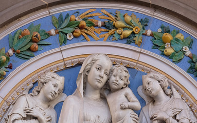 Obraz premium Madonna with Child and Two Angels, lunette by Giovanni Buglioni, above the entrance of the Badia Fiorentina in Florence, Tuscany, Italy