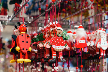 New year market. Set of holiday decorations and christmas tree toys hanging at new year trade fair shop window.