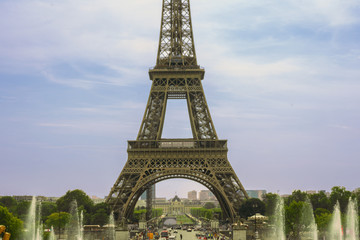 Fototapeta na wymiar Eiffel Tower on blue cloudy sky