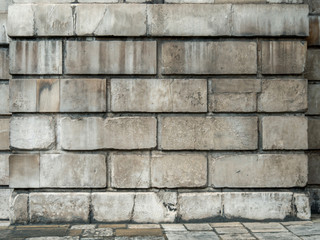 Cracked grey grunge brick wall background.