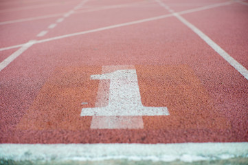 Abstract texture and background of empty running track with number one on the floor