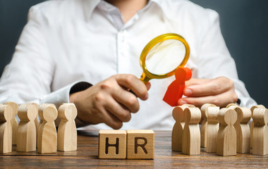 The HR examines a candidate red figure. Recruiting new workers, headhunters Human resources. Search...
