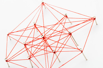 A large grid of pins connected with string. Communication, network concept