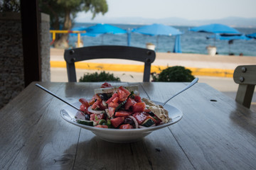 Greek salad on a table near the sea