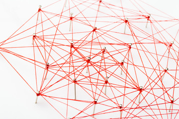 A large grid of pins connected with string. Communication, network concept