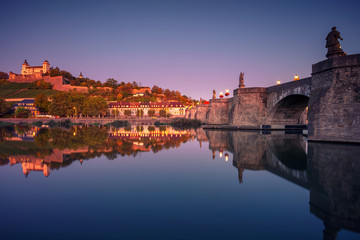 Obraz premium Wurzburg, Germany. Cityscape image of Wurzburg with Old Main Bridge over Main river and Marienberg Fortress during beautiful autumn sunrise.