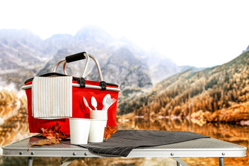 Autumn picnic table of free space for your decoration and fall background of mountains and lake 