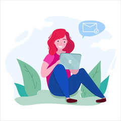 girl sit with a tablet on the ground in a park