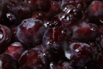 Fresh juicy black plums underwater close-up