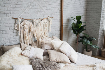 Cosy bedroom with eco decor. Wood and nature concept in interior of room. Scandinavian interior, real photo. Hygge decoration.Modern scandinavian  bedroom with plants and dream hunters.