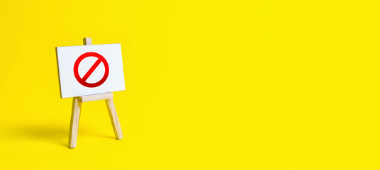 Stand with a canvas and a red prohibition sign NO. Restrictions, lifting the ban. proprietary for...
