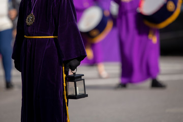 Holding a candle lantern, Holy Week