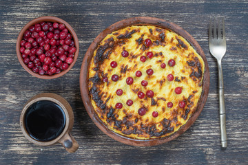 Sweet cottage cheese casserole with raisins and semolina on wooden table. Ceramic bowl with baked cottage cheese casserole , closeup, top view