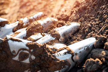 Close up of iron teeth loader excavator bucket with parts of soil