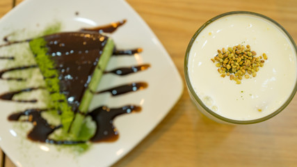 Tasty matcha cake with cold tea for dessert in a Korean restaurant.