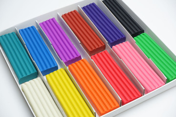 Obraz premium Multi-colored plasticine sticks in a cardboard box.