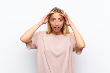 Blonde young woman over isolated white background with surprise facial expression