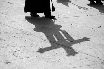 Shadow of a cross in a procession, Holy Week