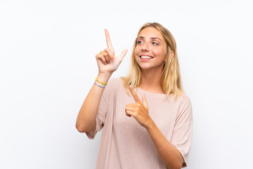 Blonde young woman over isolated white background pointing with the index finger a great idea