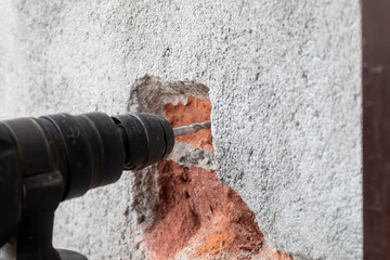 Closeup of Electric Drill Making Hole in Concrete Wall