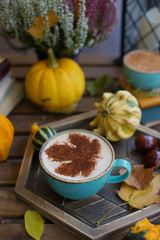 Cup of coffee with cinnamon on an open table