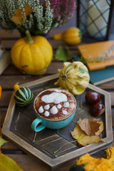 Cup of coffee with cinnamon on an open table